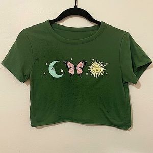 Green crop top with graphic moon, sun, and butterfly. Size small
